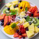 A beautifully arranged tropical pineapple platter, showcasing fresh pineapple and other juicy fruits.