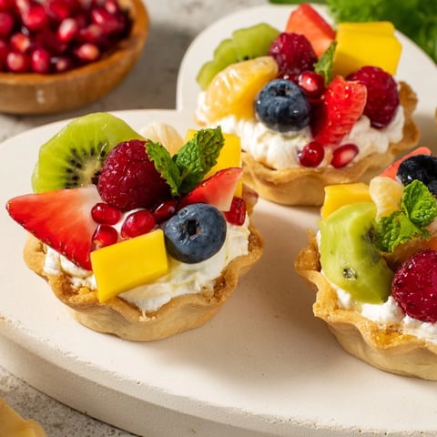 Heart Shaped Fruit Tart Board on a romantic table, featuring vibrant, sweet fruit atop creamy filling.