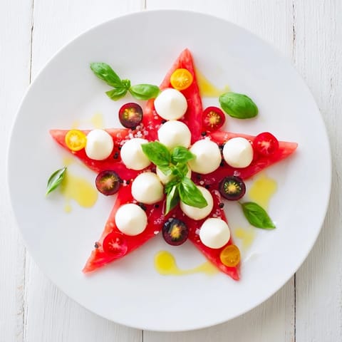 Fresh Starfish Caprese Salad with juicy tomatoes, creamy mozzarella, and a balsamic drizzle.